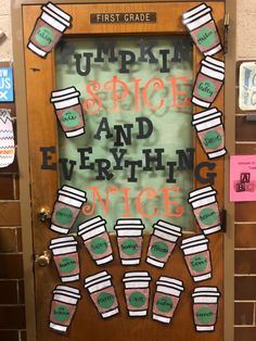 a door decorated with coffee cups and writing on the front, which reads pumpkin spice and everything nice