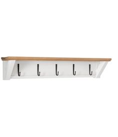 a white wall mounted shelf with hooks and two wooden shelves on each side, against a white background