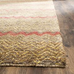 a brown and red rug on top of a wooden floor