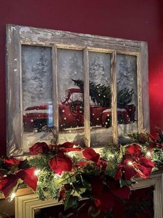 an old window decorated with poinsettis and christmas lights