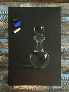 a drawing of a glass bottle with a blue stopper next to it on a wooden surface