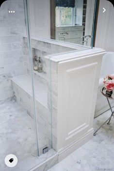 a bath room with a stand up shower