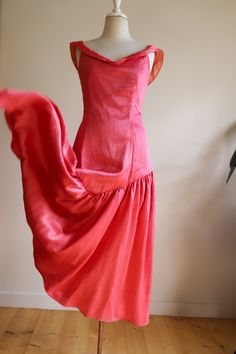 This is an exquisitely made late 70s special occasion maxi dress  in superb condition. It is both gloriously figure hugging and demure at the same time - a rare combination!  A perfect salmon pink with palest oyster lining the craftsmanship is superb.  Miles of covered buttons and beautiful button loops along with sophisticated construction attest to hours of painstaking work.  This will fit a size 6-8 UK beautifully.  With its high neckline and lower back it's shaped figure hugging bodice and f Floor-length Bias Cut Maxi Dress For Party, Bias Cut Floor-length Maxi Dress For Party, Vintage Summer Cocktail Evening Dress, Backless Bias-cut Maxi Dress With Fitted Bodice, Backless Maxi Dress With Bias Cut Fitted Bodice, Fitted Bodice Backless Maxi Dress With Bias Cut, Backless Bias Cut Maxi Dress With Fitted Bodice, Summer Maxi Dress With Bias Cut For Evening, Cocktail Maxi Dress With Bias Cut And Fitted Bodice