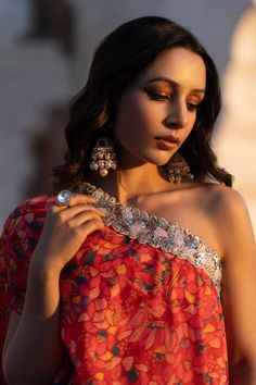 Ruby red padded kurta with leaf print and pearl, metallic dori and green, red bead embroidered neckline. Paired with sharara.
Components: 2
Pattern: Printed, Embroidery
Type Of Work: Leaf, pearl, dori, bead
Neckline: Asymmetric
Sleeve Type: One shoulder sleeve
Fabric: Dola Silk
Color: Red
Other Details: 
Tiered sharara
Occasion: Sangeet - Aza Fashions Fusion Style Pre-draped Saree With Dupatta For Festive Occasions, Festive Fusion Style Pre-draped Saree With Dupatta, Festive Fusion Pre-draped Saree With Dupatta, Multicolor Pre-draped Saree With Gota Work, Festive Fusion Sharara With Traditional Drape, Fusion Style Pre-draped Saree With Cutdana, Fusion Style Party Saree With Dupatta, Festive Fusion Style Dupatta For Party, Festive Fusion Style Party Dupatta