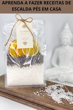 a bag filled with white rice next to a buddha statue and an orange slice in it