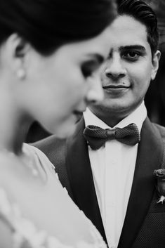 a man in a tuxedo looking at his bride