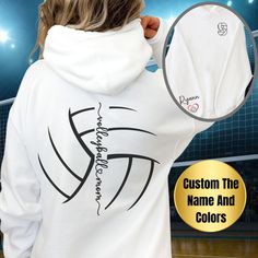 the back of a woman's white hoodie with an image of a volleyball ball on it