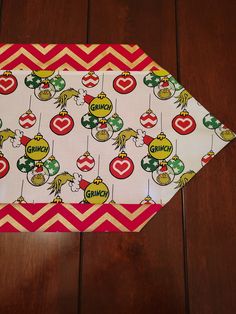 a close up of a paper plate on a wooden table with an ornament pattern