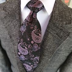 Make a statement at your next formal event with our high quality Black Purple Paisley Silk Tie Pocket Square Cufflink Set. Perfect for weddings or any occasion that calls for formal wear, this set is sure to elevate your look and make you stand out in the crowd. Made from luxurious silk, the tie features a bold paisley pattern in black and purple, while the pocket square and cufflinks perfectly coordinate to complete the look. 100% Silk Handmade Package Includes: Tie, Pocket Square & Cufflinks. Silver Suit And Tie Accessories For Formal Occasions, Luxury Silver Suit And Tie Accessories For Formal Occasions, Elegant Black Cufflinks For Wedding, Elegant Black Wedding Cufflinks, Elegant Silver Suit And Tie Accessories For Formal Events, Elegant Adjustable Silver Suit And Tie Accessories, Elegant Black Cufflinks For Business, Elegant Silver Suit And Tie Accessories For Party, Men Ties