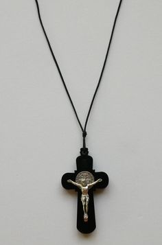 "Beautiful Saint Benedict Black Wood Necklace with Silver Tone Corpus 1-1/2\" Crucifix and Cord.  DIMENSIONS OF CROSS: 3\" x 1-3/4\" (75mm x 45mm) CORPUS: 1-1/2\" x 1-1/4\" (40mm x 33mm) MATERIAL: Great Quality Wood / Silver Tone Alloy CORD: 27\" long Use it as a regular pectoral necklace with cord included.  Every Crucifix comes gift packed for ease of display or gift giving. Made in Italy Come Visit Us at Our New Store! Please feel free to email me with questions about this item. Also please c Crucifix Necklace, Saint Benedict, Wood Necklace, Gift Packs, Black Wood, Necklace Etsy, Jewelry Necklace Pendant, Pendant Necklaces, Silver Tone