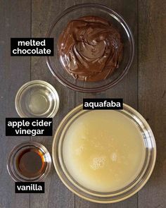 ingredients to make chocolate frosting in glass bowls on a wooden table with labels labeled