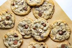 chocolate chip cookies are arranged on a cutting board