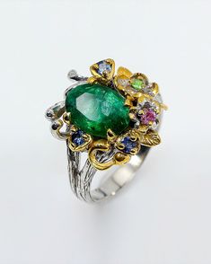 This ring is totally stunning and unique in design and craftsmanship! It is made from sterling silver and plated with white and yellow gold to create a unique mix of colors. The main gemstone is green Emerald in stunning quality and shine. Surrounding tiny gemstones are ruby, sapphire and chrome diopside. Nature inspired design is created to inspire your creativity and achievements ♥ The design can be made with gemstones of your choosing ♥ Each order will be gift wrapped beautifully ♥ QUALITY: E Opal And Sapphire Ring, Jewelry Big, Green Tourmaline Ring, Green Emerald Ring, Nature Inspired Rings, Raw Stone Ring, Ethiopian Opal Ring, Ring Flower, Jewelry Mirror