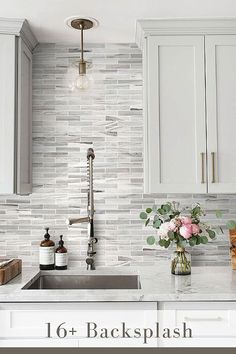 a kitchen with white cabinets and marble backsplash in the center is featured on this page