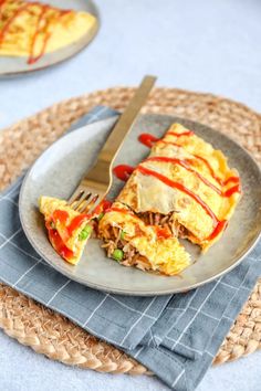 an omelet on a plate with a knife and fork