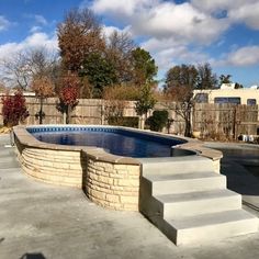 an empty swimming pool with steps leading up to it