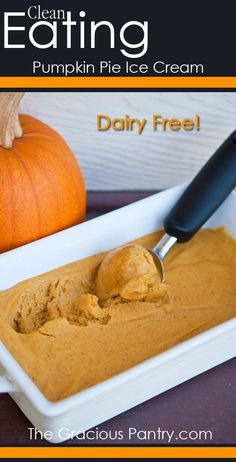 pumpkin pie ice cream in a white bowl with a spoon on the side and an orange pumpkin next to it