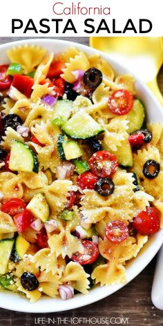 pasta salad in a white bowl on top of a wooden table