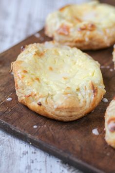 some type of cheese danish on a cutting board