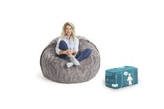 a woman sitting on top of a bean bag chair next to a blue box