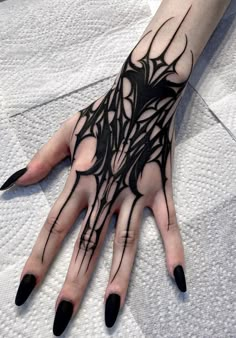 a woman's hand with black ink on it