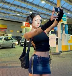 a woman is taking a selfie with her cell phone in the air at an airport