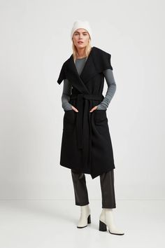 A black wool knee-length vest for all seasons, Marcella's Erica Vest is a styled sleeveless vest with a belted trench that comes together above the chest. Elegant Vest, Elevated Style, Wool Vest, Outerwear Vest, Vest Outfits, The A Team, Sleeveless Vest, Black Wool, Chunky Knit