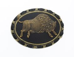 a black and gold brooch with a lion on it