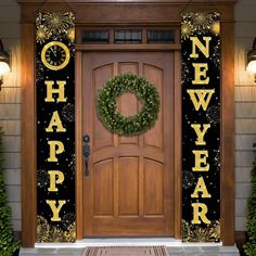 a front door decorated with a wreath and happy new year's eve banner on it