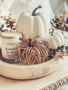 pumpkins and candles are sitting on a tray