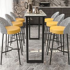 a bunch of chairs that are around a table