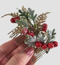 "This pretty Christmas bridal hair comb features a lovely collection of frosty berries, Dusty Miller leaves, and little fronds of golden fern. This would look lovely just plunked into the back of an up and down do or gifted to bridesmaids for a festive accessory. The purchase of this listing is for one Christmas berry comb with the following specifications and options: Style: Holly Berries, Dusty Miller, and Golden Fern. Measurements: 4\" length x 1.5\" width. Hair Comb Finish: Nickel, Gold, Bro Christmas Hair Pins, Christmas Bridal Hairpiece, Christmas Hair Piece, Peony Hair Piece, Ruby Hair Comb, Poinsettia Hair Clip, Christmas Headpiece, Winter Wedding Hair, Flower Hair Accessories Wedding