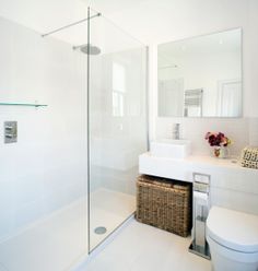 a bathroom with a toilet, sink and shower stall