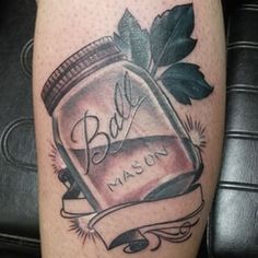 an image of a tattoo on someone's leg with the word bad written in a jar