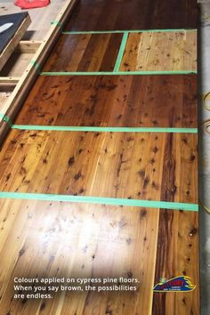 wood flooring being installed on the side of a building with green tape around it