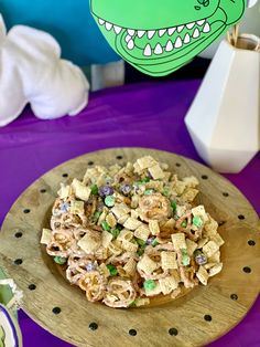 there is a bowl of cereal on the table next to a plate with an alligator head