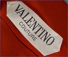 a label on the back of a red jacket that says,'walking couture '