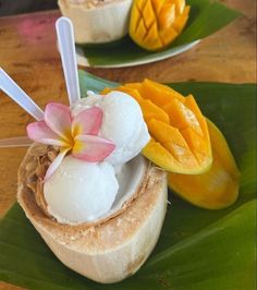 there are two desserts on the table with fruit and ice cream in each bowl