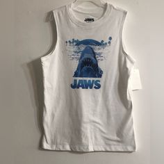 Jaws Boy’stank Top Shark Beach Trees Graphic Crewneck Pull Over. Color White. Relax Lightweight Comfortable Fitted. Material 60% Cotton 40% Polyester. Size M (8) Shark Tee Shirt, Blue Summer Tank Top For Playwear, Sleeveless Cotton T-shirt For Playwear, Casual White Tops For Playwear, White Summer Playwear Top, White Tops For Summer Playwear, Casual Blue Tank Top For Playwear, White Cotton Tank Top For Playwear, Casual Sleeveless T-shirt For Playwear