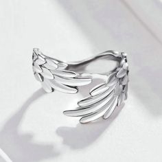 Our Wings Ring is designed for those who seek elegance and individuality.Inspired by the majestic wings of birds, this timeless accessory embodies a sense of empowerment and strength, making it the perfect statement piece for both men and women. Its sleek and minimalist design ensures versatility, allowing you to effortlessly pair it with any outfit, from casual to formal. Its wraparound design gracefully curves around your finger, providing a comfortable fit while exuding a sense of effortless Silver Angel Wings, Feather Ring, Silver Wings, Feather Jewelry, Finger Rings, Timeless Accessories, 925 Jewelry, Sterling Silver Charm, Silver Charms