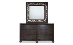 a dresser with a mirror on top of it