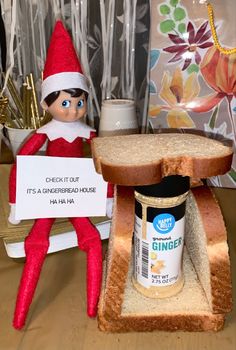 an elf is holding a sign next to a peanut butter and jelly sandwich