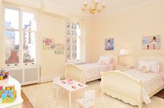 a bedroom with two twin beds and a baby crib