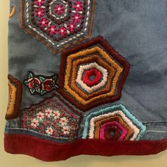 an embroidered patchwork design on a denim jacket