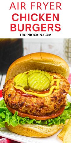 an air fryer chicken burger with lettuce, tomato and pickles on it