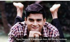 a man is posing for a photo with his hands in the air and smiling at the camera