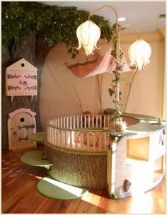 a baby crib in the middle of a room with lots of toys on it