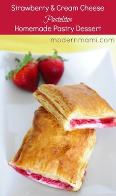 two pastries sitting on top of a white plate with strawberries in the background