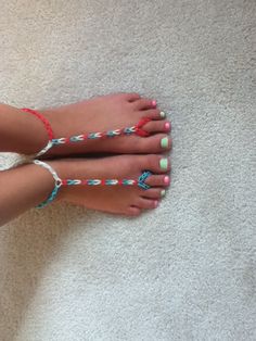 a woman's feet with different colored beads on them