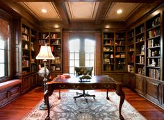 a large library with lots of bookshelves and furniture